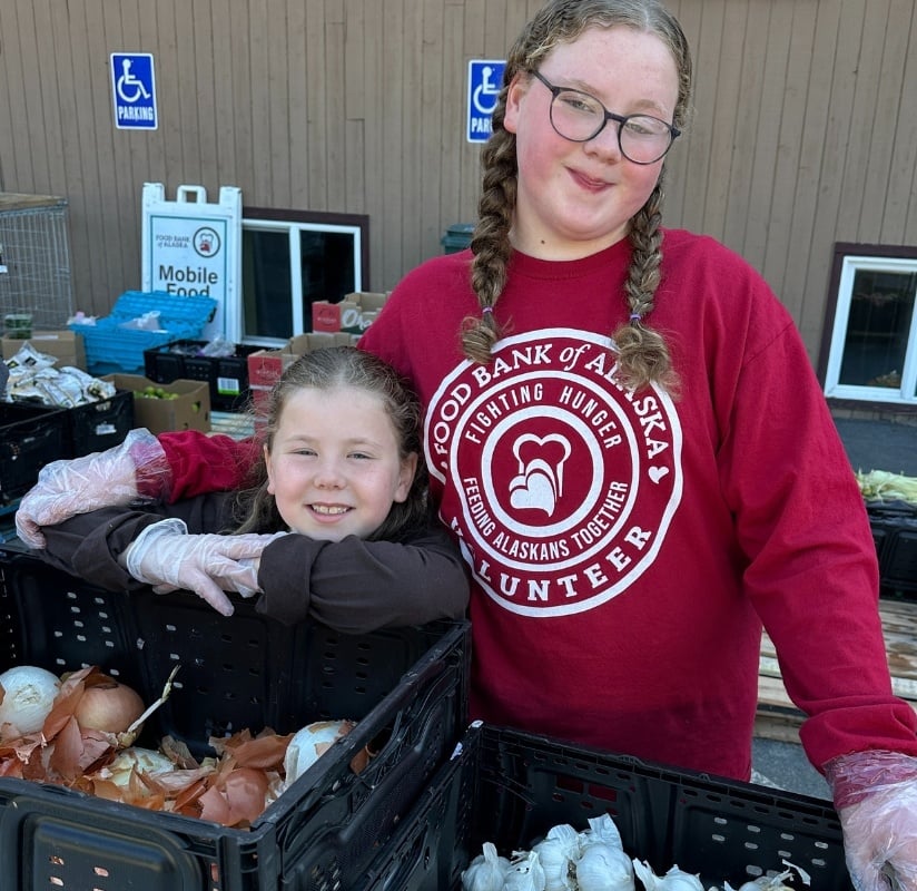Children volunteering together at an event